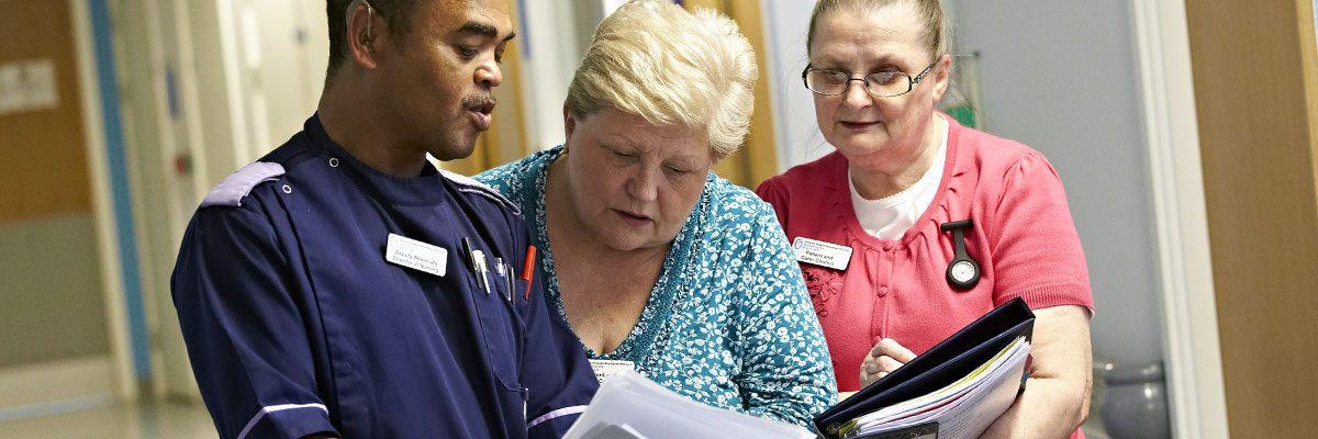 Staff and patient carer council members in discussion