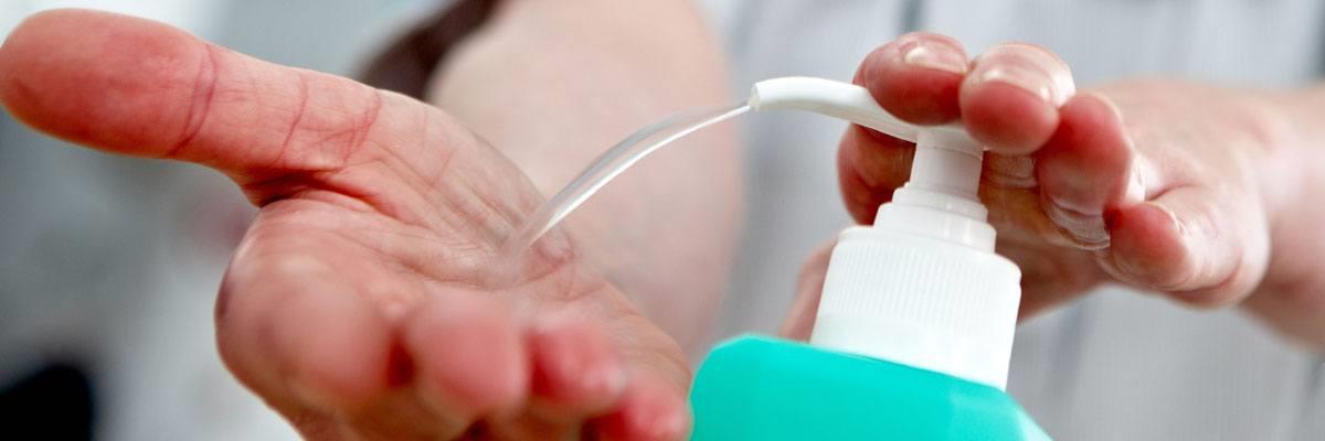 Nurse washing hands with handrub